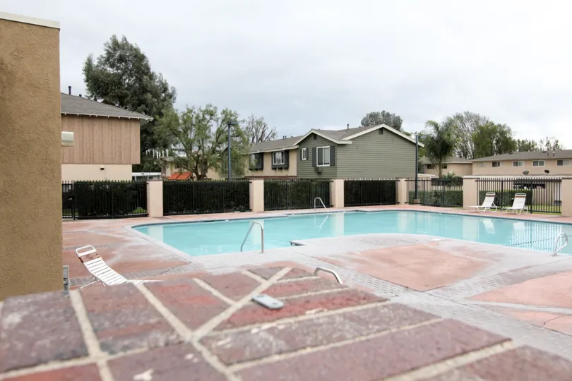 THE VILLAS IN THE Influential Square WITH THE SWIMMING POOL, CHAIRS, PLANTS, TREES