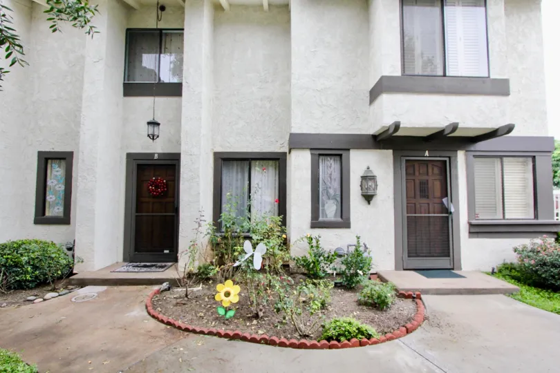 A modern townhouse with dark gray trimmings in the Macaw Cove community.