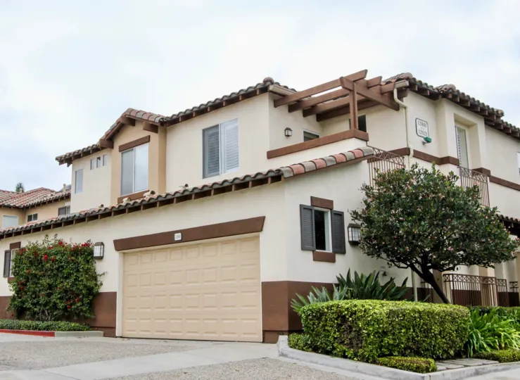 A street level view of the Orchards Community with Spanish tile, landscaping and spacious double garage