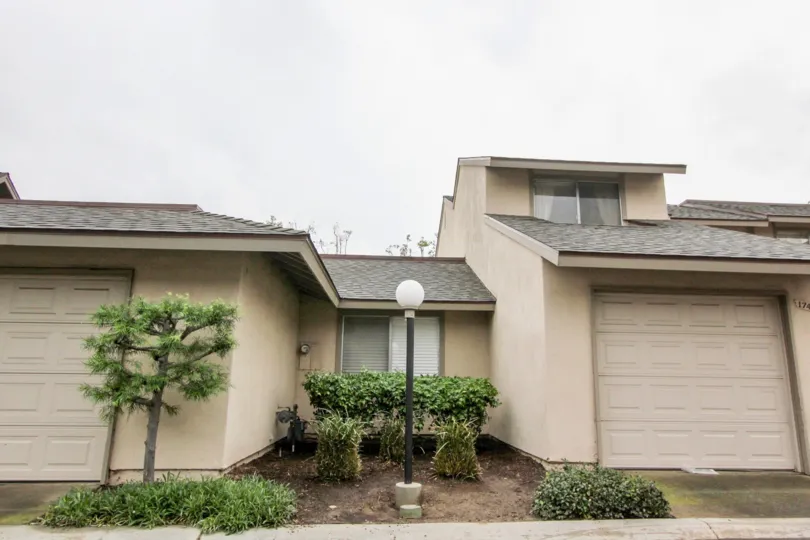 What appears to be an old condo house with a tan exterior and in Tustin