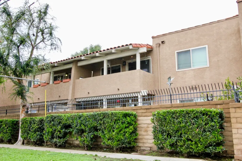 A sunny day in the area of Rancho San Juan, condos, outside, fence, bushes, balcony