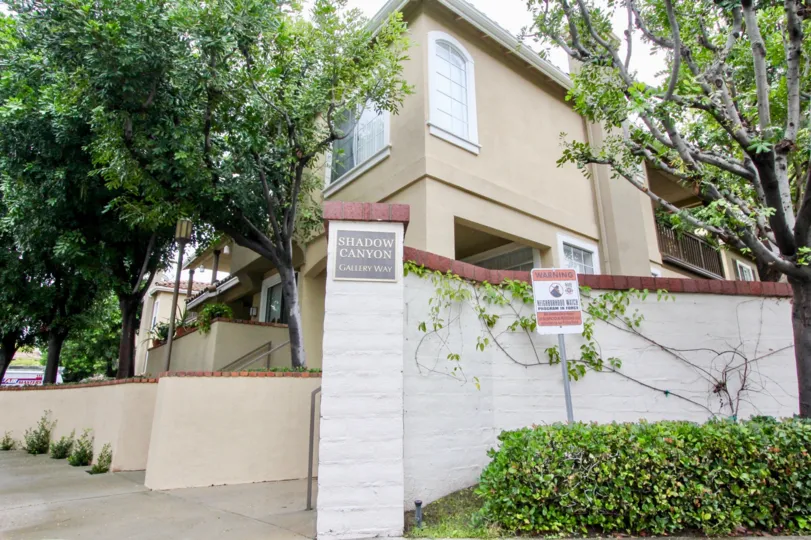 Treed entry view of residences in Shadow Canyon in Tustin, California. Neighborhood Watch is in effect at these residences to assist with security.