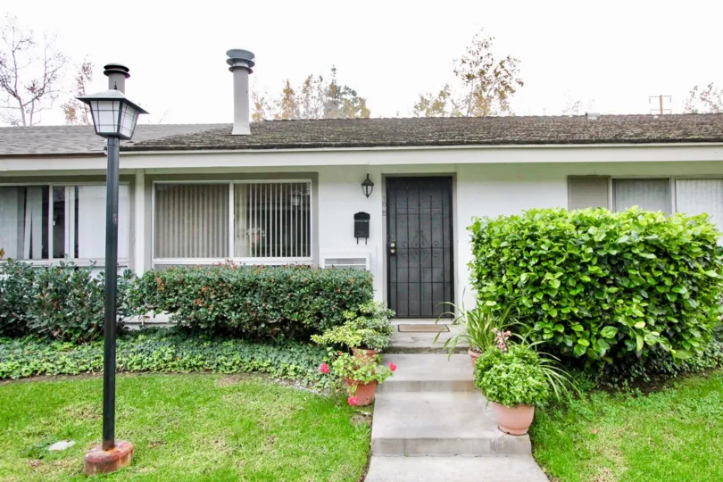 A great home in Sycamore Garden with tons of bushes in front.