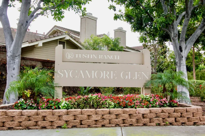 Welcome sigh surrounded by flowers in the Sycamore Glen community.