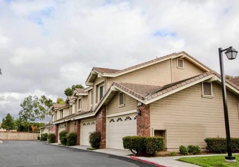 Traditional townhouses with horizontal cladding and tile roofing in the Sycamore Glen community.