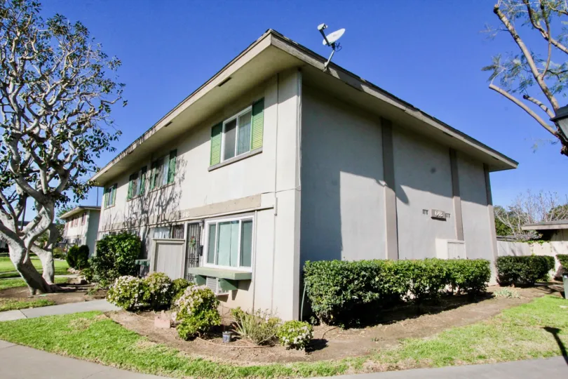 A sunny day show casing a residential corner lot at Tustin Acres with mature trees