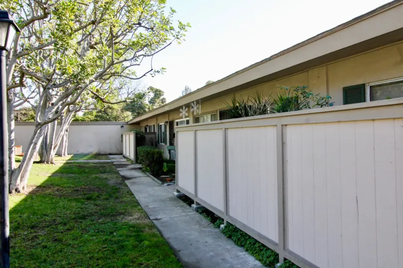 THE FLAT IN THE TUSTIN ACRES WITH THE PLANTS, TREES, WALL