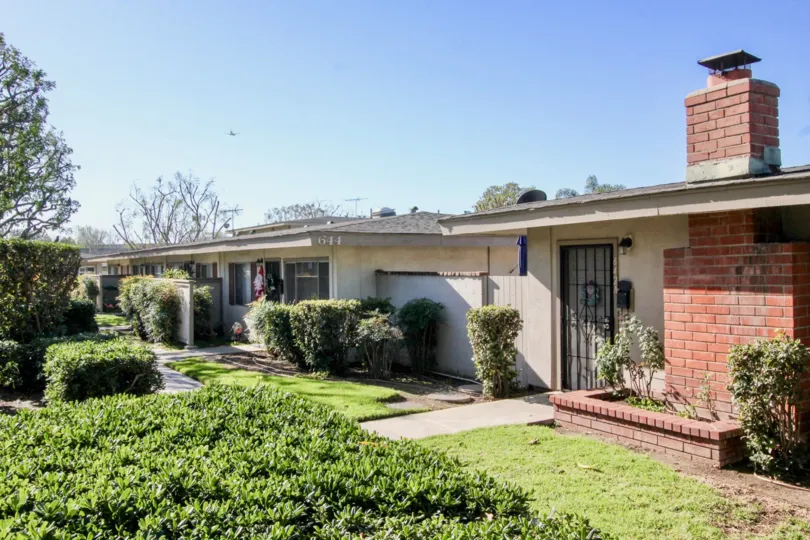 THIs image views the beautiful house with the fabulous lawn with trees which is located in the community of Tustin Acres, city of Tustin