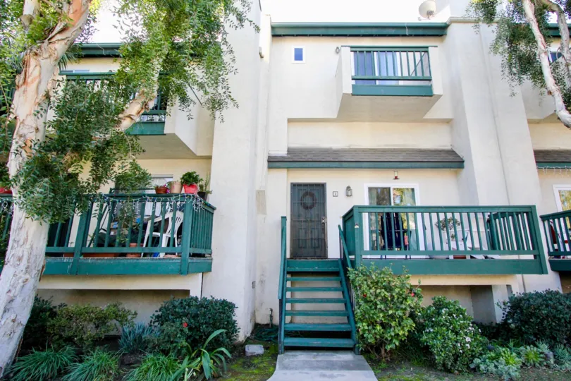 THE APARTMENT IN THE TUSTIN COMMONS WITH THE DISH ANTENNA, CHAIR, BALCONIS, PLANTS, TREES
