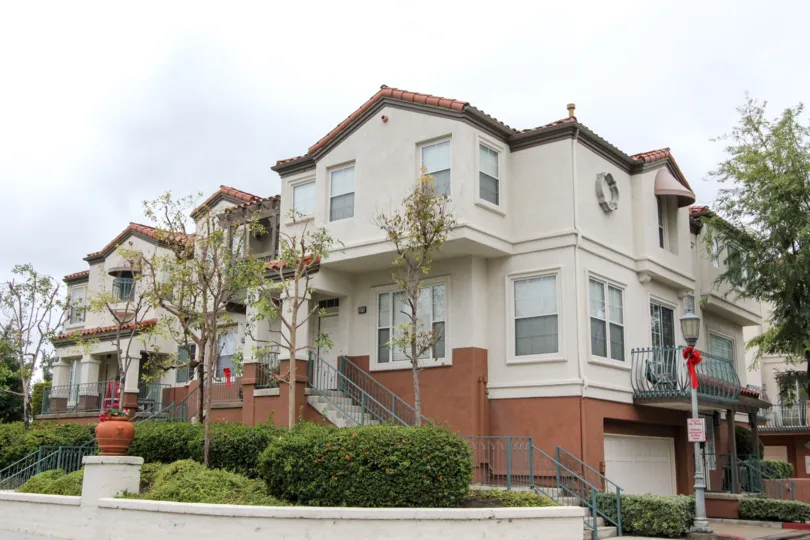 A three-storey townhouse painted in dark and light color in the Tustin Del Verde community.