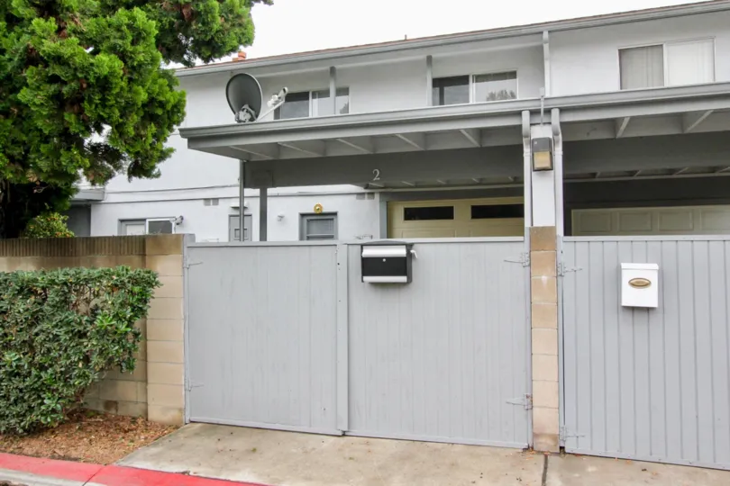 Villas with dish antenna and post box at maingate surrounded with trees in Tustin Imperial of Tustin