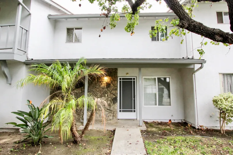 A roof overhangs provides shade for a condo in the Tustin Imperial community