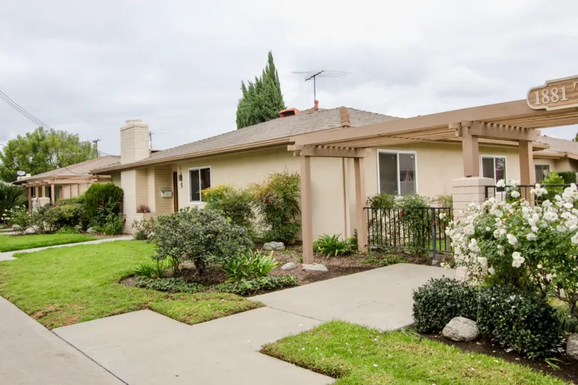THE 1881TH FLAT IN THE TUSTIN PARK VILLAS WITH THE GRASSLAND, FLOWER PLANTS, ROCKS