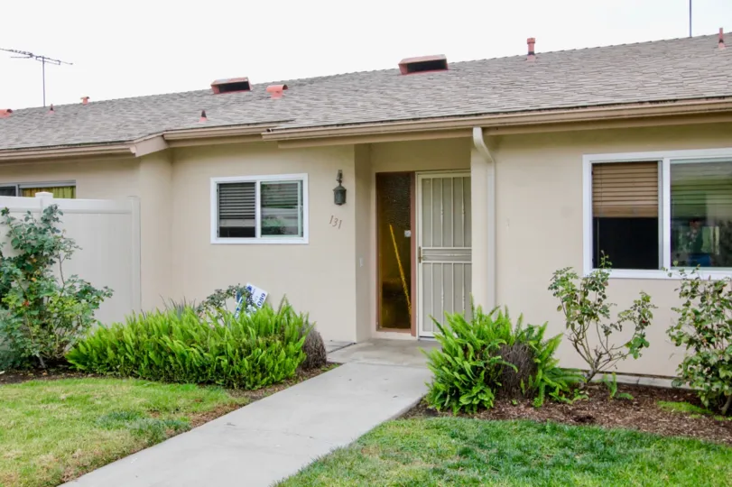 Twin houses separted by a wall with a small garden in the front yard
