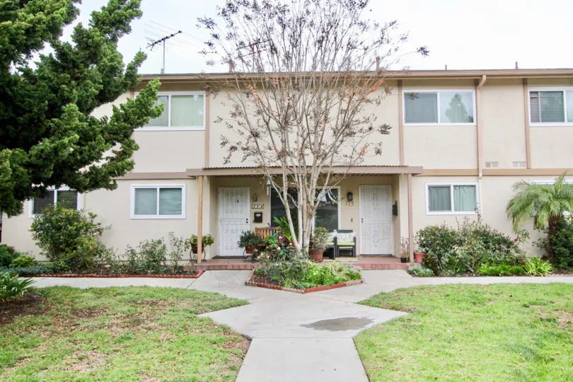 THE 175TH FLAT IN THE TUSTIN PARK VILLAS WITH THE LAWN, PLANTS, TREES