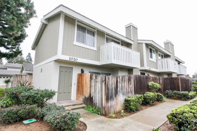 THE 1020 FLAT IN THE TUSTIN PINES WITH THE PLANTS, PATHWAY, TREES