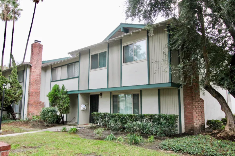 Two brick chimneys sit on the sides of townhomes in the Tustin Place community