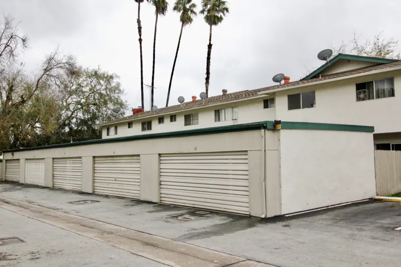 A multiple-car garage with green gutter in the Tustin Place community.