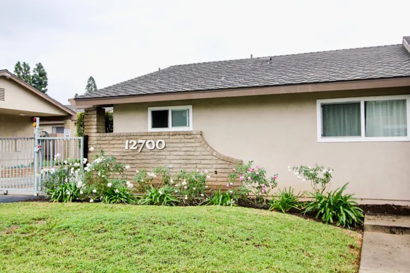 THE 12700 FLAT IN THE TUSTIN VERDES WITH THE FLOWER PLANTS, LAWN