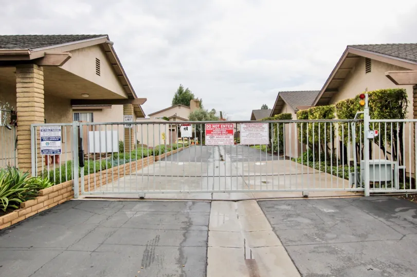 A sunny day at the private gated entrance to Tustin Verdes community with tall automatic gate