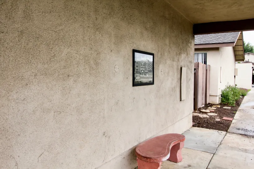 Picture Frame and bench on outside wall of a house in the Tustin Verdes neighborhood.
