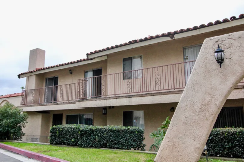 Two-storey apartments with pinkish gates in the Villa Vallerto community.