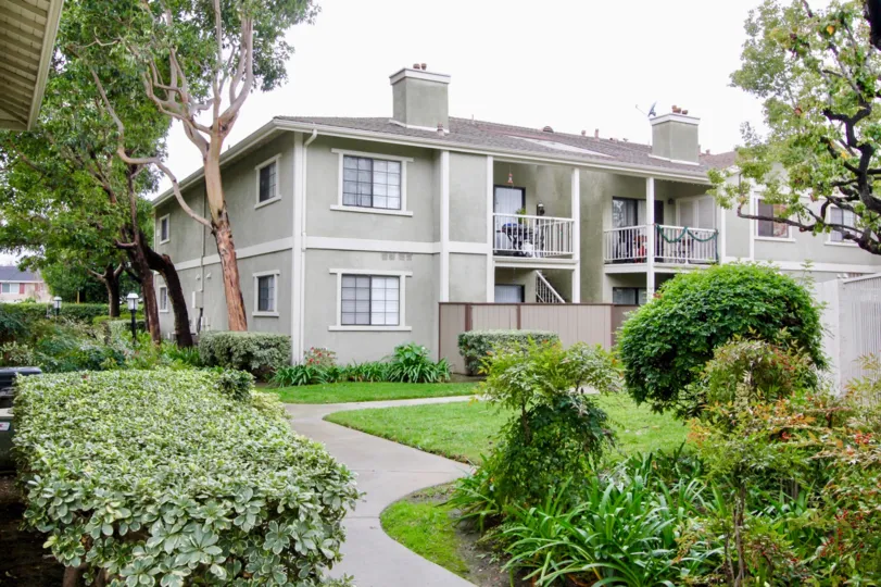 View of apartment complex on overcast day, plants outside