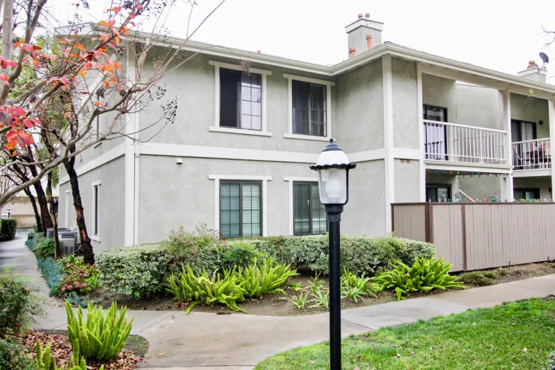 A sunny day at the modern Village Homes in Tustin with charming lighting and flowering trees