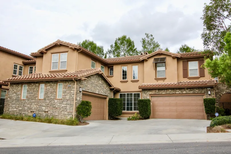 A beige color bunglow with a wide garage and drive way in the Canterbury community