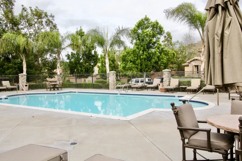 The sunny day in the Canterbury with swimming pool and picnic tables.