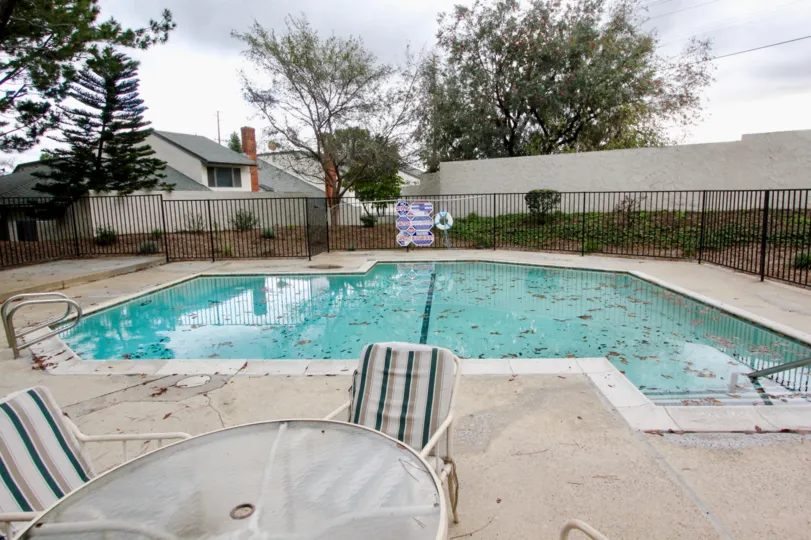 A pool area with leaves fallen into it in the Charter Hill community