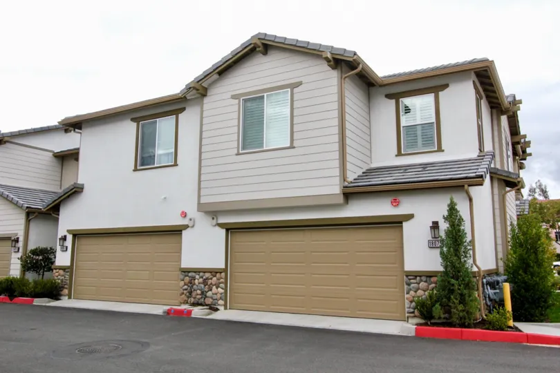 townhomes in light brown and white with garages in covington classics community in yorba linda, california.