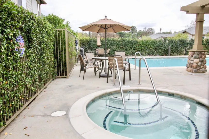 Children and adult swimming pool is present at Covington Classics with dinning tables and cutting bushes