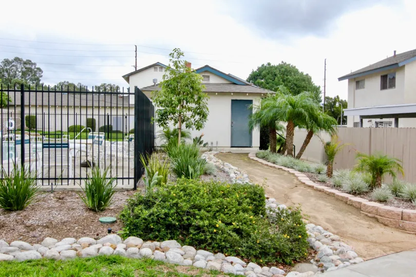 A narrow muddy pathway leading to villas inside the Fairgreen Homes community