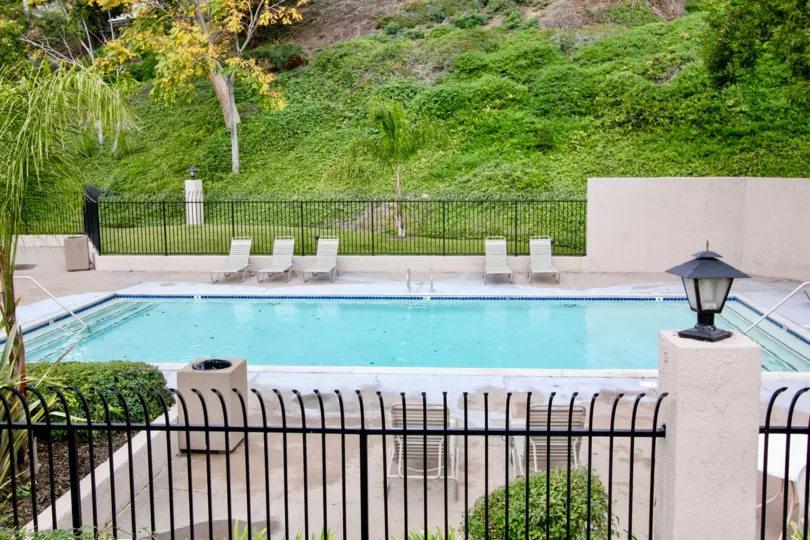 Gated private swimming pool with chaise lounges and hillside view in Fairmont Hill, Yorba Linda, CA.