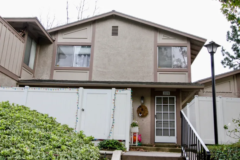 brown two story home with white gate in the farimont hill community in yorba linda, ca..