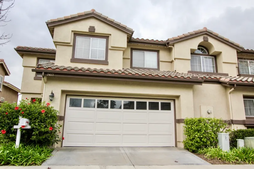 Beautiful home front with attached garage and red flowers in La Terraza I community, in Yorba Linda, California