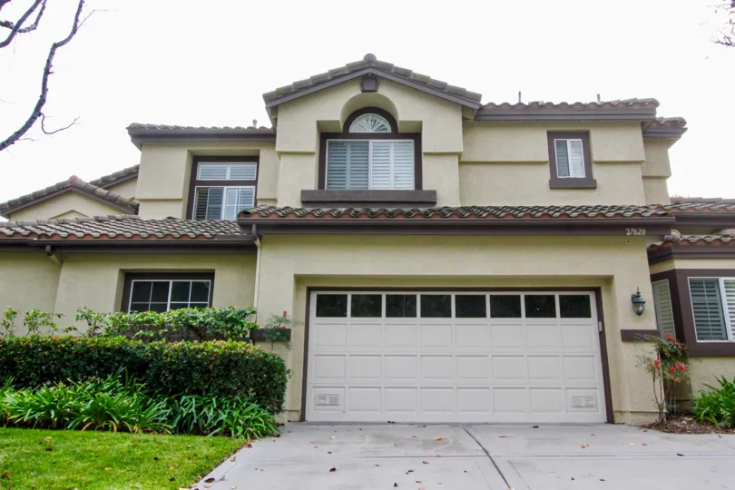 A two story home in La Terraza I with a garage and large windows.