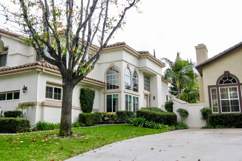 A very large white home with well groomed lawn in La terraza l community in yorba linda, california.