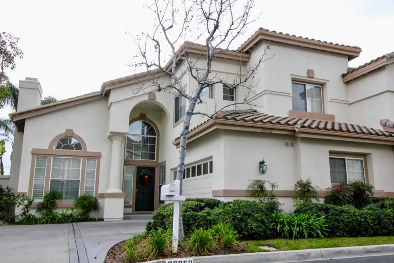 A large villa with a huge garden and a front drive inside the La Terraza II community