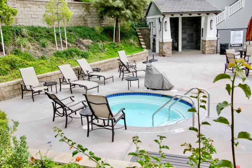 A bright day in the Palisades at Vista Del Verde with a small pool and chairs.