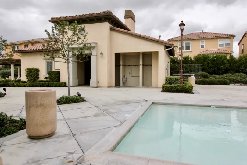 A cloudy day in the Villaggio with a swimming pool and building.