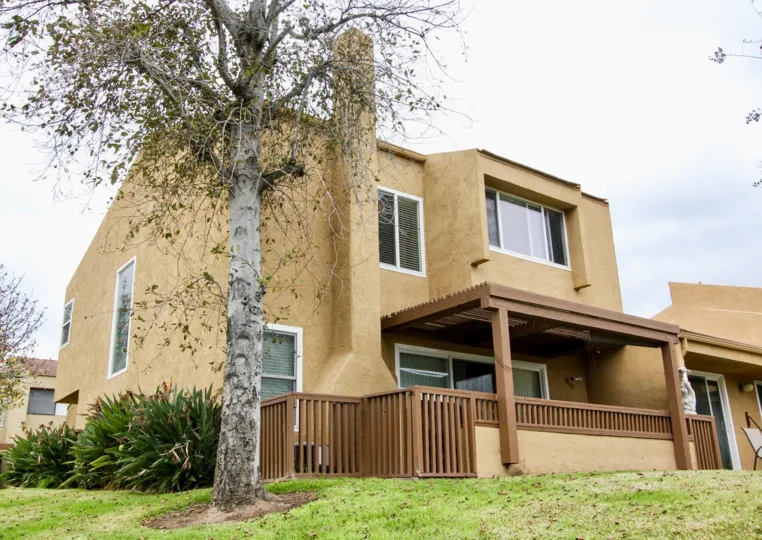 Dry tree are placed inside of the lawn in Yorba Linda Knolls with villa and bushes