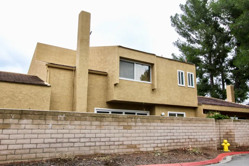 A great day in the Yorba Linda Knolls with a building and compound wall.