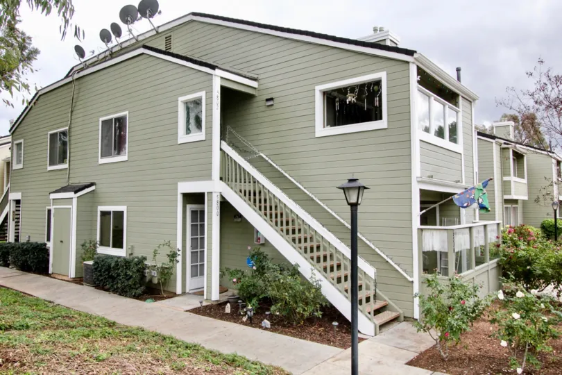 A gray two story apartment building in the Yorba Linda Villages on a cloudy day.