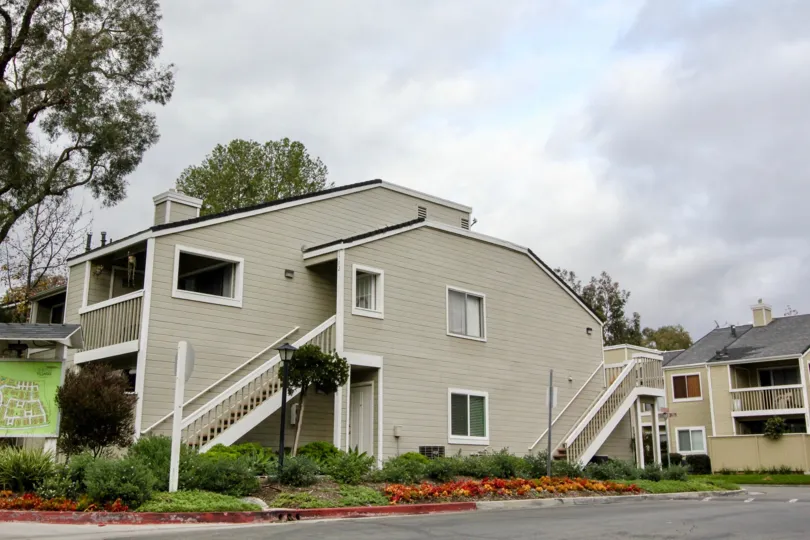 A cloudy day in the Yorba Linda Villages side view of a ash color building.