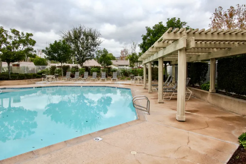 Lounge chairs around a pool at Yorba Meadowood in Yorba Linda, CA