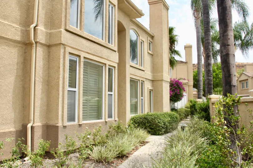 Beige apartments, a sunny day in the community of Altia, Corona CA with beautiful greenery