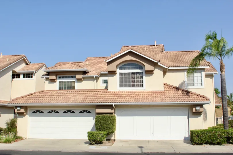 Spanish architecture with shingled roof and palm tree