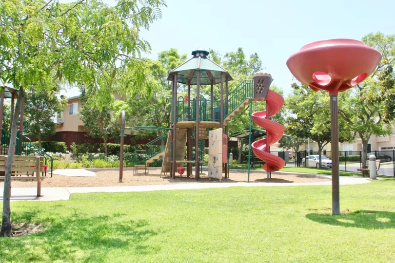 Children's playground with slides and park bench in Carlisle